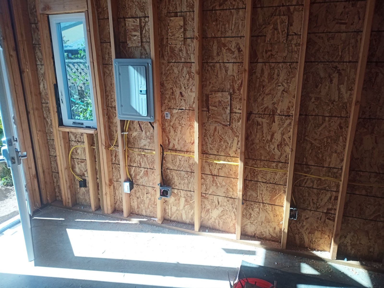 Garage rough-in wiring and sub-panel installation on a framed wall in Vancouver, WA by Brightwise Electric